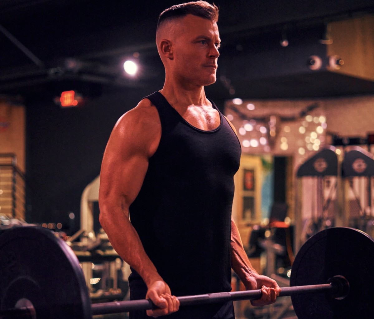 Rawson Thurber lifts a barbell in the gym