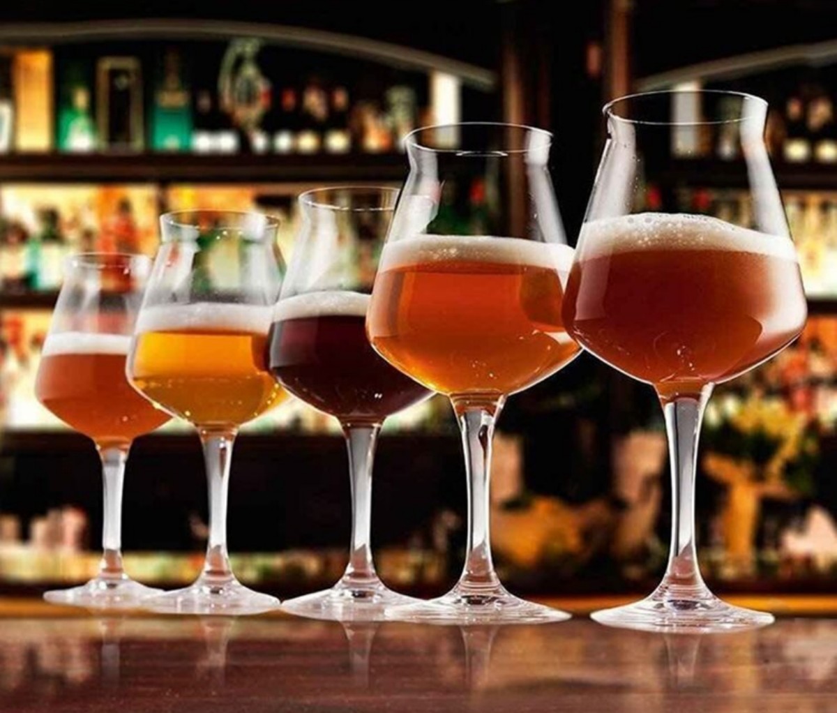 Rastal Teku Set of 6 glasses lined up on a bar filled with beer