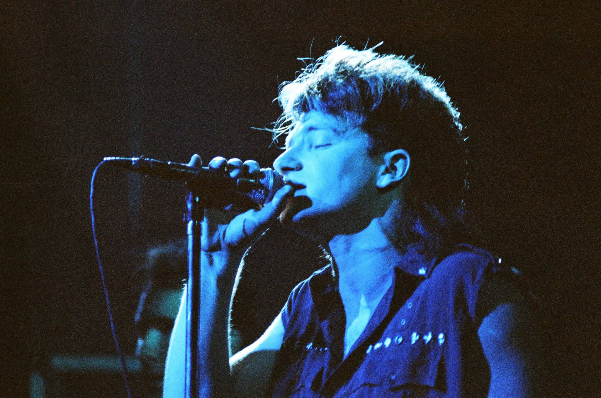 LONDON, UNITED KINGDOM - MARCH 21: Vocalist Bono of Irish rock band U2 performs on stage at Hammersmith Odeon on the 'War' tour, on March 21st, 1983 in London, England.