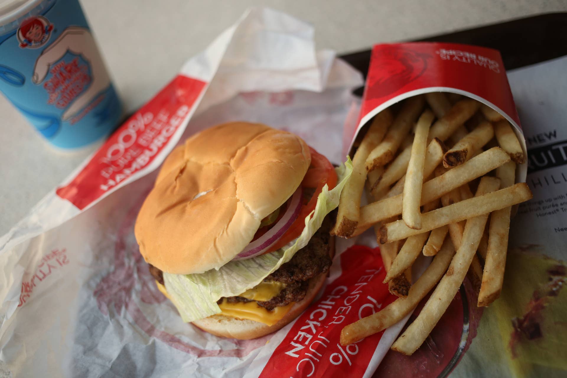 A Wendy's classic double cheeseburger and french fries are arranged for a photograph at a restaurant location in Mt. Vernon, Illinois, U.S., on Wednesday, July 29, 2015.