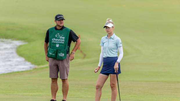 Nelly Korda (USA) and her caddie Jason McDede wait to putt on the ninth green during the second round of The Chevron Championship golf tournament.