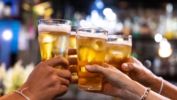 Group of happy toasting beer at brewery