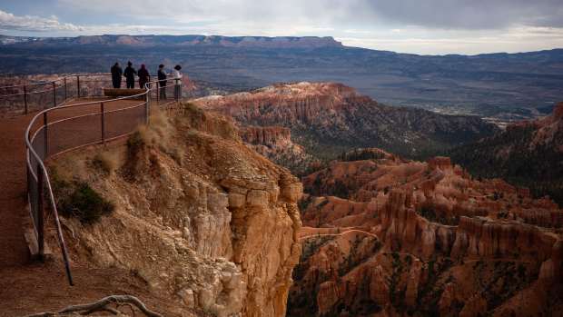 BRYCE, UTAH - APRIL 29: Visitors look out from upper inspiration Point at Bryce National Park on April 29, 2025 in Bryce, Utah. The bodies of two people who fell to their deaths from Inspiration Point at Bryce Canyon National Park, authorities said, after apparently climbing over a safety railing at the popular Utah overlook, were recovered altering being discovered by tourists on Tuesday. (Kent Nishimura/Getty Images)