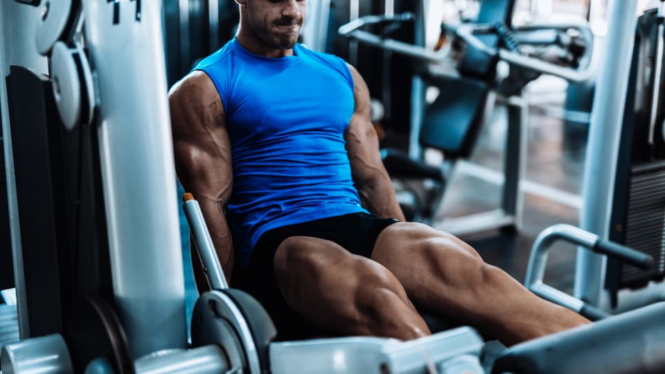 Muscular man doing a leg extension