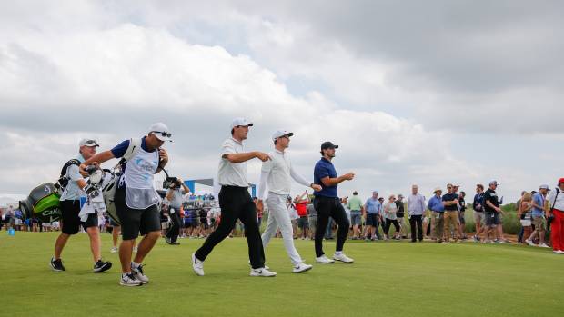 May 9, 2019; Dallas, TX, USA; The group pf Scottie Scheffler and Dylan Frittelli and Tony Romo walk to the second green during the first round of the AT&T Byron Nelson golf tournament at Trinity Forest Golf Club.