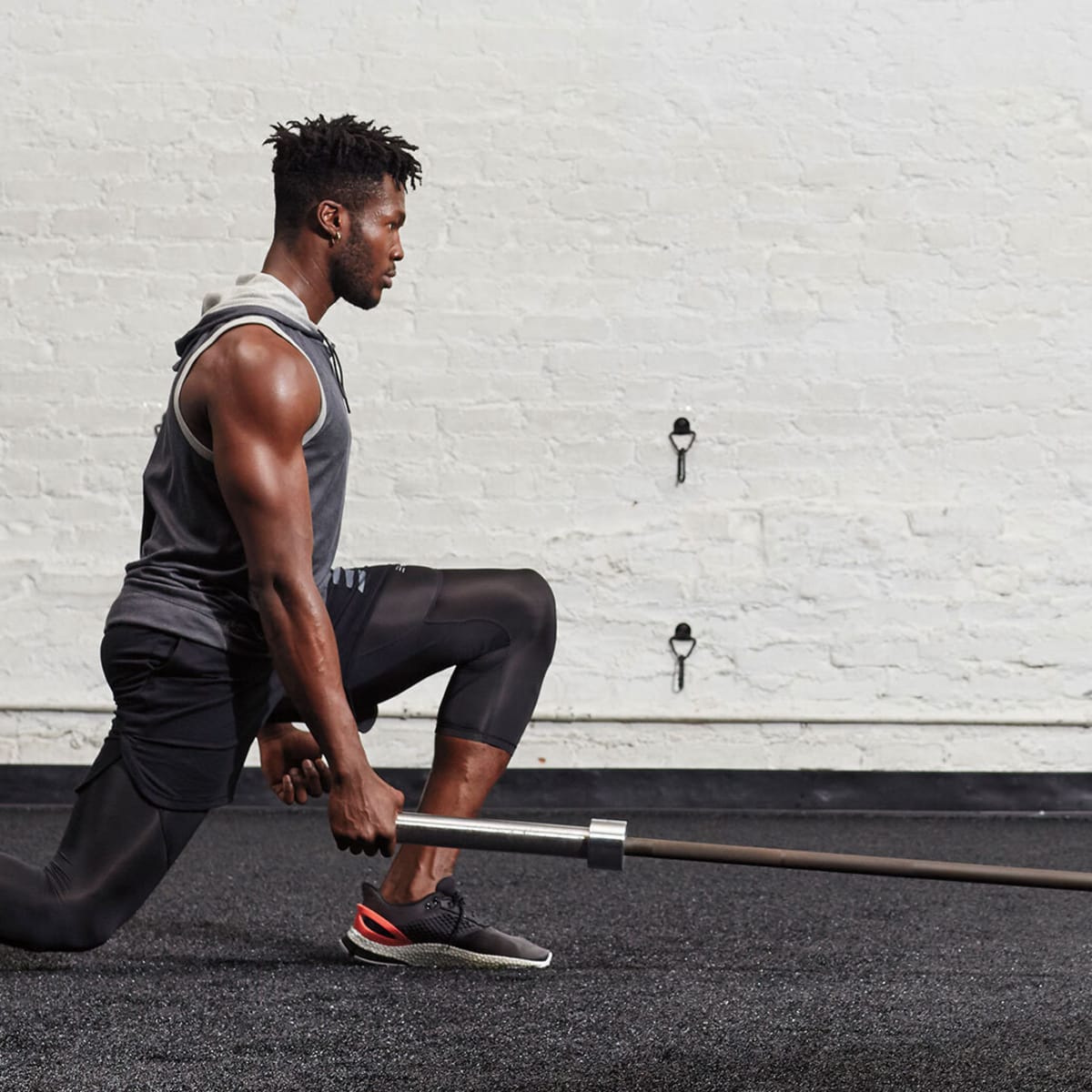 Healthy Young Man Standing Strong In The Gym And Flexing Legs