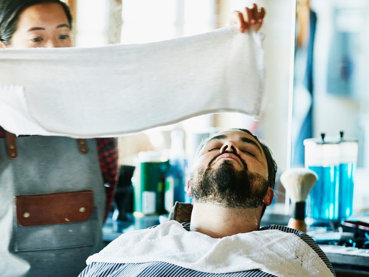The Reason Your Barber Puts a Hot Towel on Your Face Men s Journal