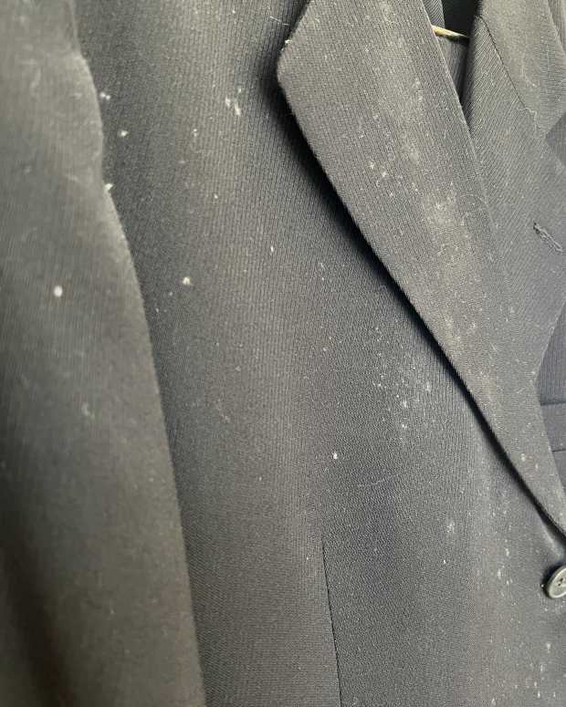 Mildew spots on a black suit.
