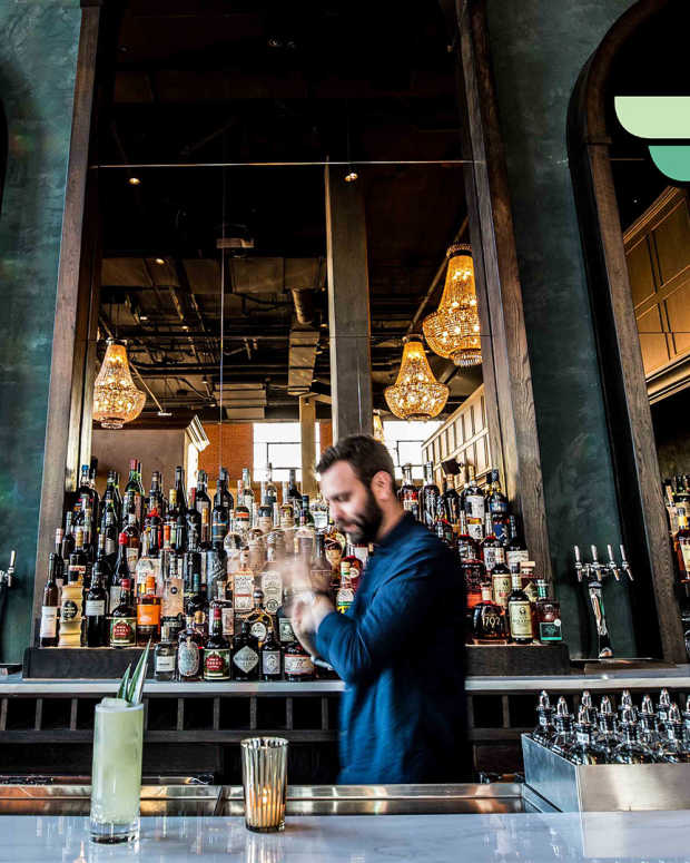 Denver Ramble Hotel, one of the best pitstops among our 50 best vacations in U.S., has a dramatic bar outfitted with oversized arched mirrors and chandeliers