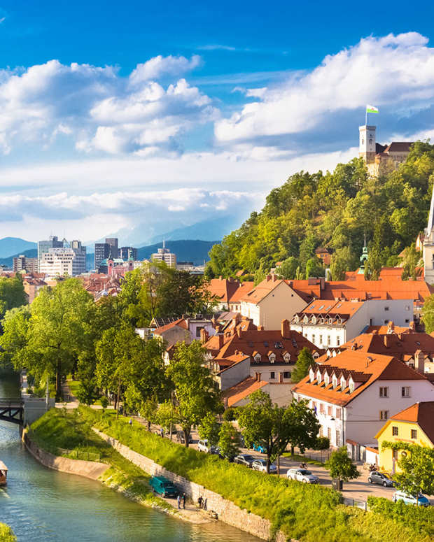 Image depicts a riverside cityscape of the Slovenian capital Ljubljana.
