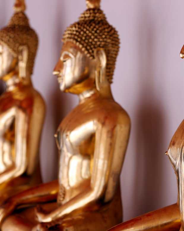 Row of golden Buddha statues in Wat Pho temple, Bangkok, Thailand.