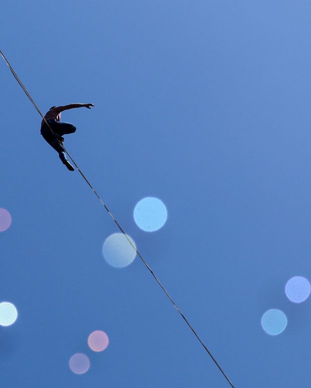 SANTIAGO, CHILE - JANUARY 3: French tightrope walker Nathan Paulin walks on the 270-meter-long taut rope, 50 meters above the ground, as he crosses Alameda Avenue on the opening day of the Teatro a Mil festival, in front of the Presidential Palace from La Moneda in Santiago, Chile on January 3, 2024. Paulin, 29, holds the world record for the longest high-altitude crossing, a little more than 2.2 kilometers on Mont Saint-Michel, in his native country. He holds several other records, including 10 Guinness World Records. (Photo by Lucas Aguayo Araos/Anadolu via Getty Images)