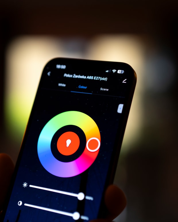 A man is seen looking at the Tuya lighting control application is seen running on an iPhone in this photo illustration in Warsaw, Poland on 20 July, 2023. (Photo by Jaap Arriens/NurPhoto via Getty Images)
