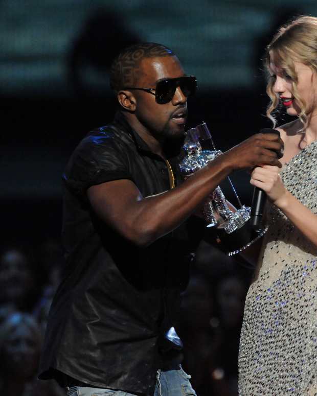 NEW YORK - SEPTEMBER 13:  Kanye West (L) jumps onstage after Taylor Swift (C) won the "Best Female Video" award during the 2009 MTV Video Music Awards at Radio City Music Hall on September 13, 2009 in New York City.  (Photo by Jeff Kravitz/FilmMagic) 