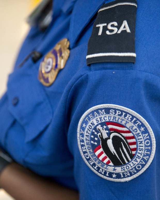A Transportation Security Administration (TSA) officer stands in the TSA pre-check area at Dulles International Airport in Dulles, Virginia, U.S., on Wednesday, Aug. 19, 2015. The TSA, part of the Homeland Security Department (DHS), reported seizing a record number of firearms at U.S. airports in 2015, a 20 precent increase over 2014.Photographer: Andrew Harrer/Bloomberg via Getty Images