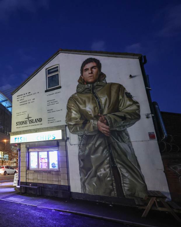 MANCHESTER, ENGLAND - NOVEMBER 26: A mural of Liam Gallagher, as part of a Stone Island advert is seen on the side of a fish and chips shop outside Etihad Stadium during the UEFA Champions League 2024/25 League Phase MD5 match between Manchester City and Feyenoord at City of Manchester Stadium on November 26, 2024 in Manchester, England. (Photo by Robbie Jay Barratt - AMA/Getty Images)