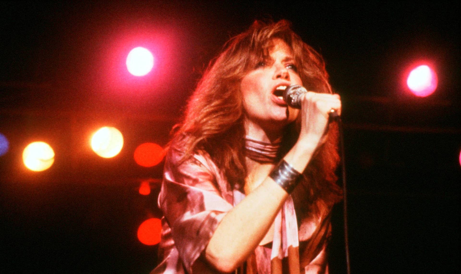Carly Simon singing onstage in the early 1970s, when the song's mystery was beginning to spread.