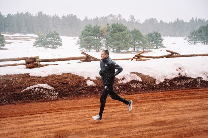 Triathlete Matt McElroy running on dirt road in snow