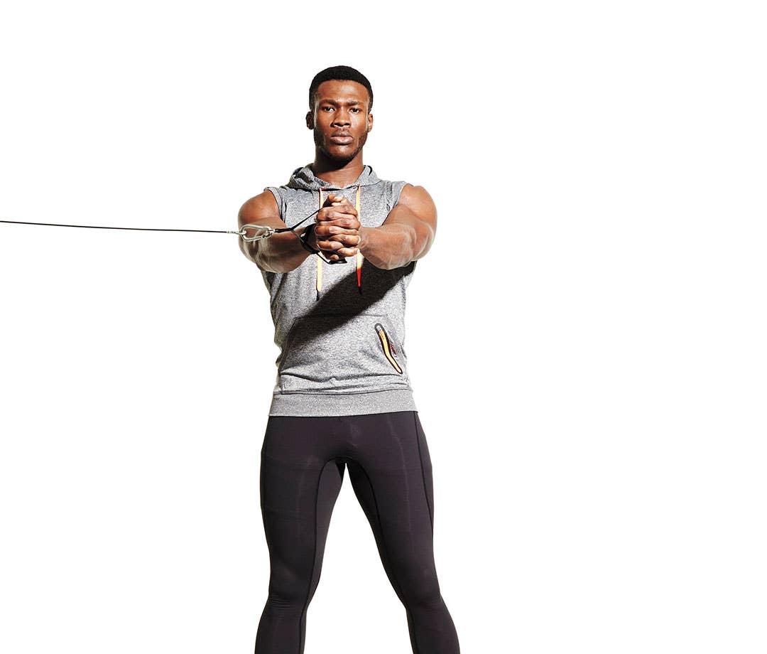 Ab Exercises: Black muscular man wearing gray sleeveless hoodie and black tights doing Pallof press