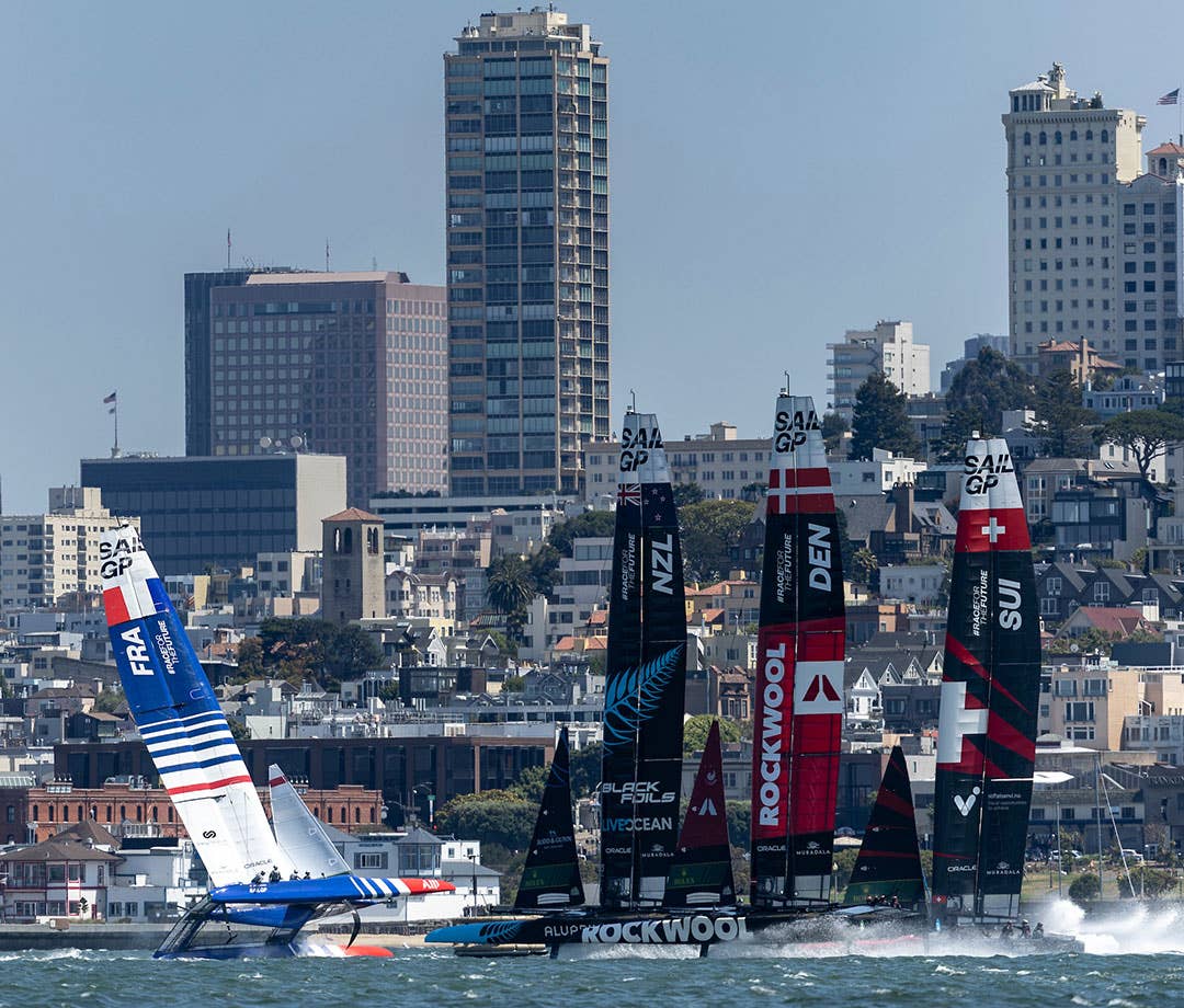 SailGP boats racing in San Francisco Bay. France boat keeling during collision with Denmark boat.