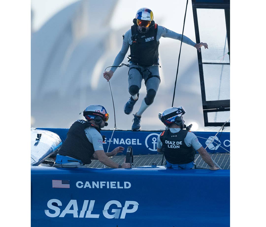 U.S. SailGP crew member Taylor Canfield hops into U.S. boat during SailGP race.