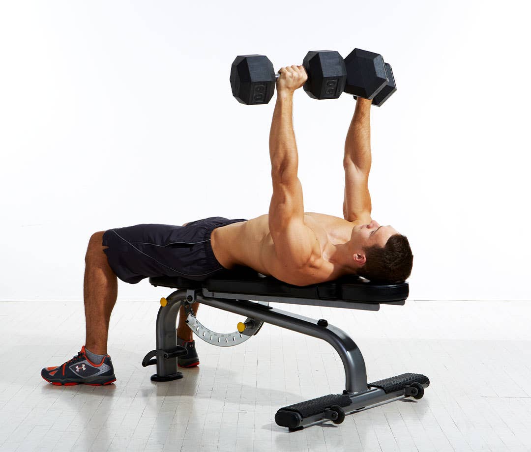 Push, Pull, Leg Workout: Shirtless caucasian man in black shorts performs dumbbell bench.