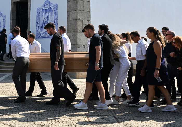 Diogo Jota's wife Rute Cardoso is consoled as the coffins of Diogo Jota and Andre Silva are brought into the Igreja Matriz de Gondomar in the town of Gondomar near Porto.