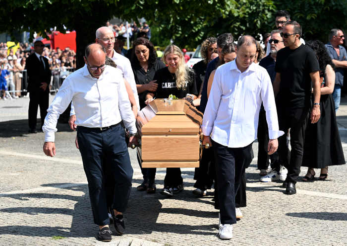 Maria Rodrigues, Wife of Andre Silva, cries as she walks with the coffin of her late husband Andre Silva as is it carried out of the Church after a funeral held for Diogo Jota and his brother Andre Silva at Igreja Matriz de Gondomar on July 05, 2025 in Gondomar, Portugal.