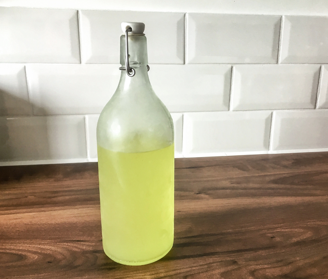 A bottle of limoncello on a kitchen counter.