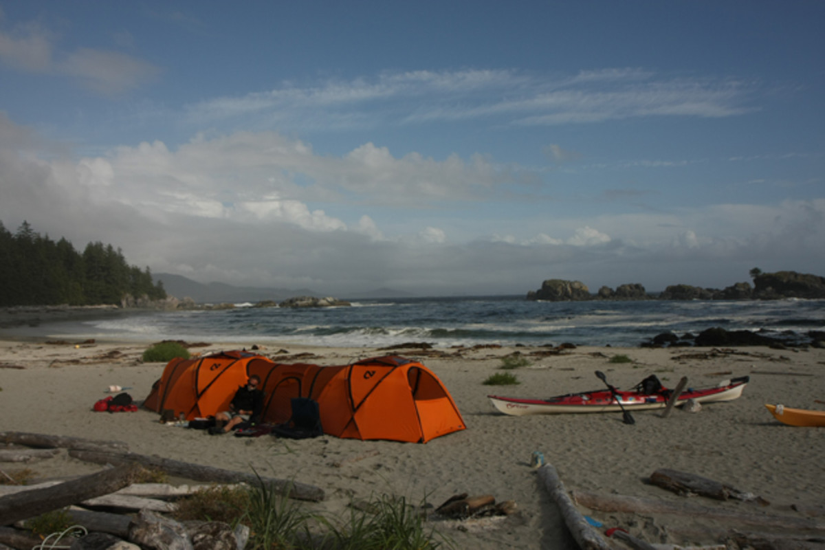 Glowing Tent And Kayak On The Beach In Front Of Shoup Glacier And