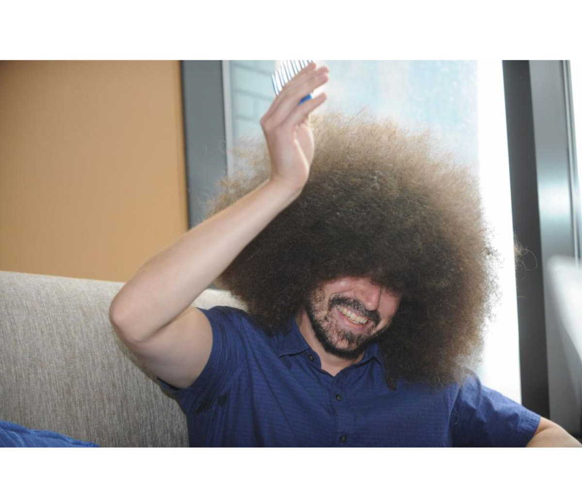 Man earns Guinness World Record for “Largest Male Afro” - Men's Journal