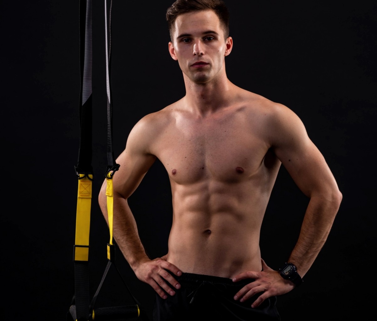 Man standing next to TRX straps. abs exercises