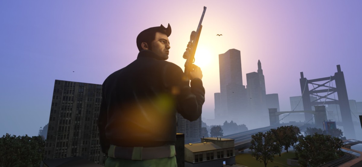 A man holding a gun with a city in the background in GTA 3 Definitive Edition