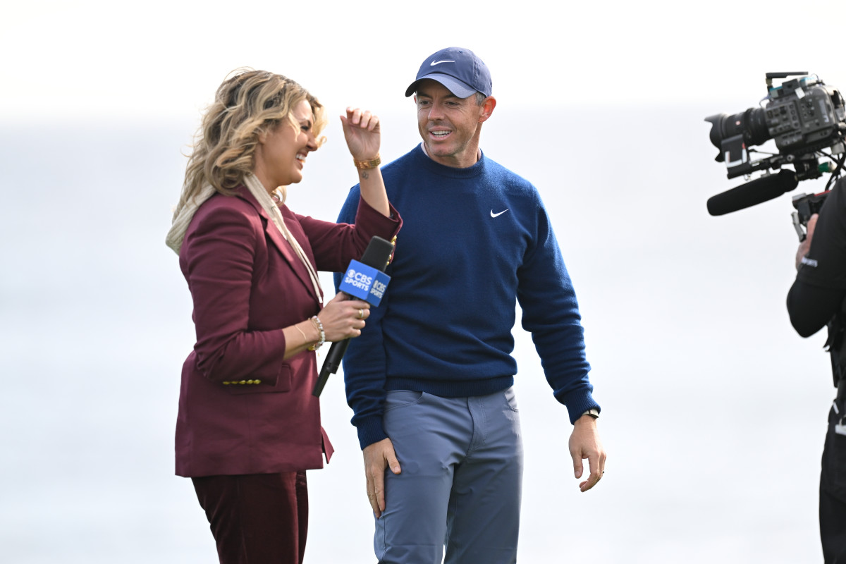 PEBBLE BEACH, CALIFORNIA - FEBRUARY 02: Rory McIlroy of Northern Ireland laughs with CBS reporter, Amanda Balionis, on the 18th green after the final round of AT&T Pebble Beach Pro-Am at Pebble Beach Golf Links on February 2, 2025 in Pebble Beach, California. (Photo by Ben Jared/PGA TOUR via Getty Images)