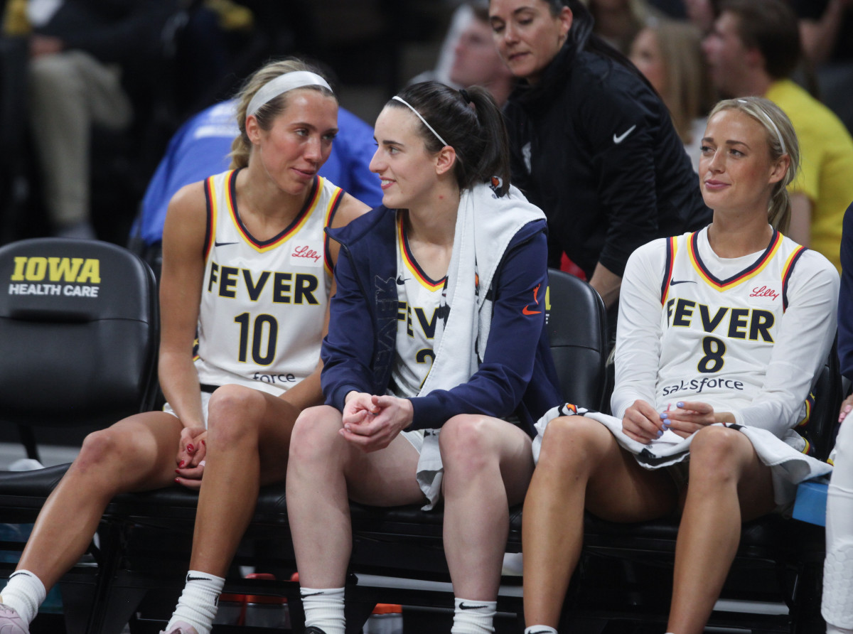 IOWA CITY, IOWA- MAY 4: Guard Lexie Hull #10, guard Caitlin Clark #22 and guard Sophie Cunningham #8 of the Indiana Fever sit on the bench during the second half against the Brazil National Team at Carver-Hawkeye Arena on March 4, 2025 in Iowa City, Iowa. (Photo by Matthew Holst/Getty Images)
