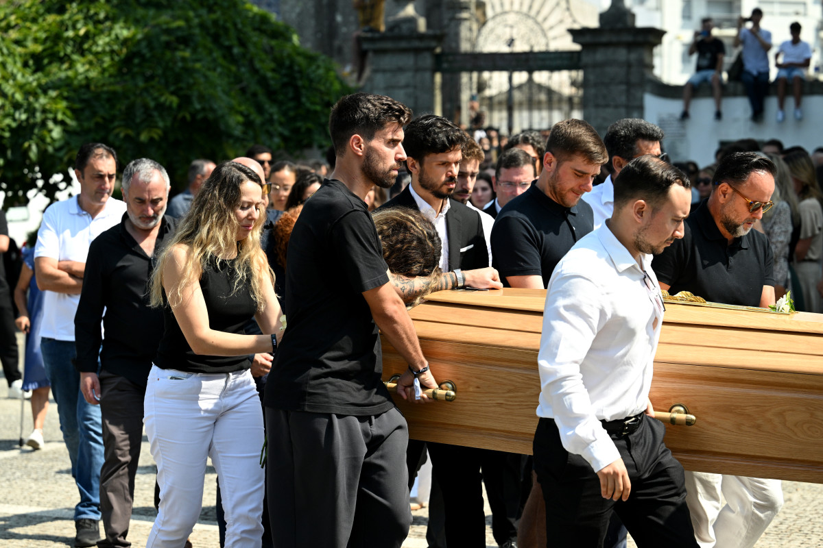 Rute Cardoso, Wife of Diogo Jota, leans on the arm of Ruben Neves, football player for Alhilal Saudi Club and the Portugal national team, as the coffin of Diogo Jota is carried out of the Church after a funeral held for Diogo Jota and his brother Andre Silva at Igreja Matriz de Gondomar on July 05, 2025 in Gondomar, Portugal.