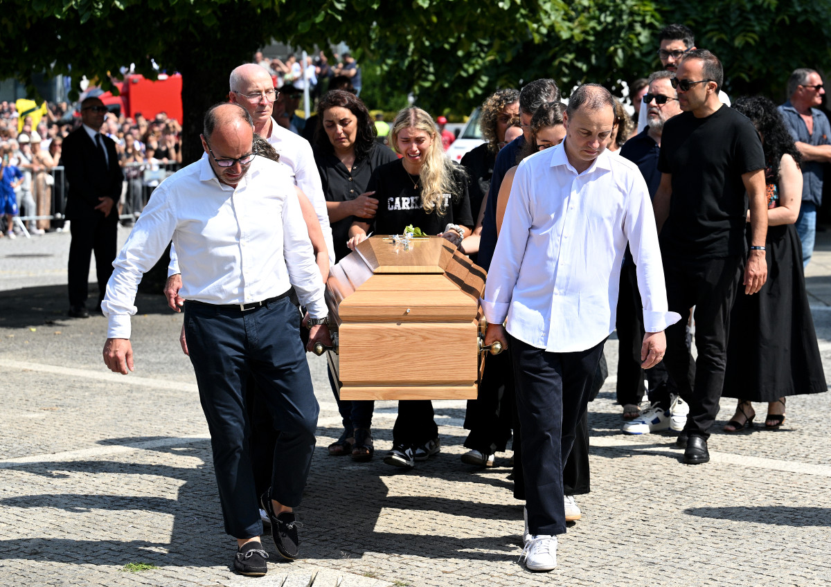 Maria Rodrigues, Wife of Andre Silva, cries as she walks with the coffin of her late husband Andre Silva as is it carried out of the Church after a funeral held for Diogo Jota and his brother Andre Silva at Igreja Matriz de Gondomar on July 05, 2025 in Gondomar, Portugal.