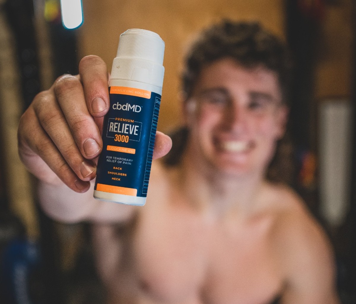 Man holding CBD pain reliever stick