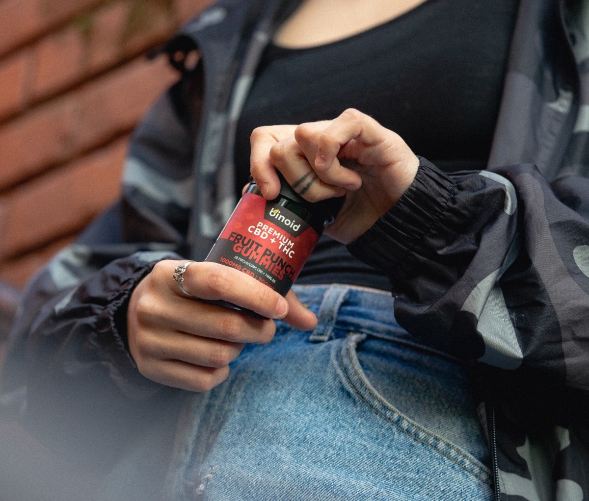 Woman holding bottle of CBD gummies