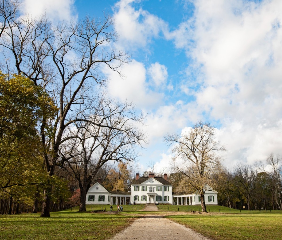 Couple walking in front of historic mansion