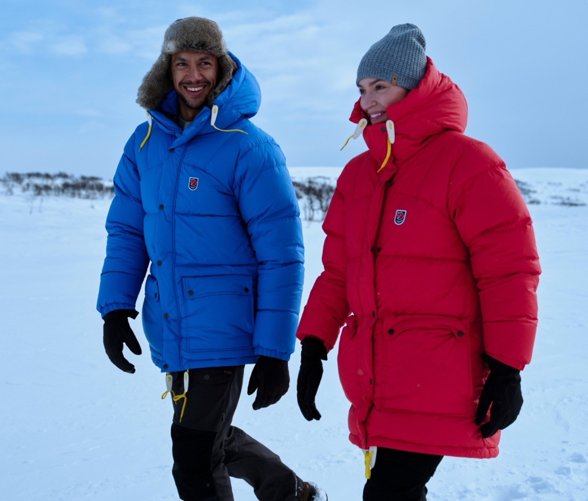 Man and a woman wearing blue and red Expedition Down jackets