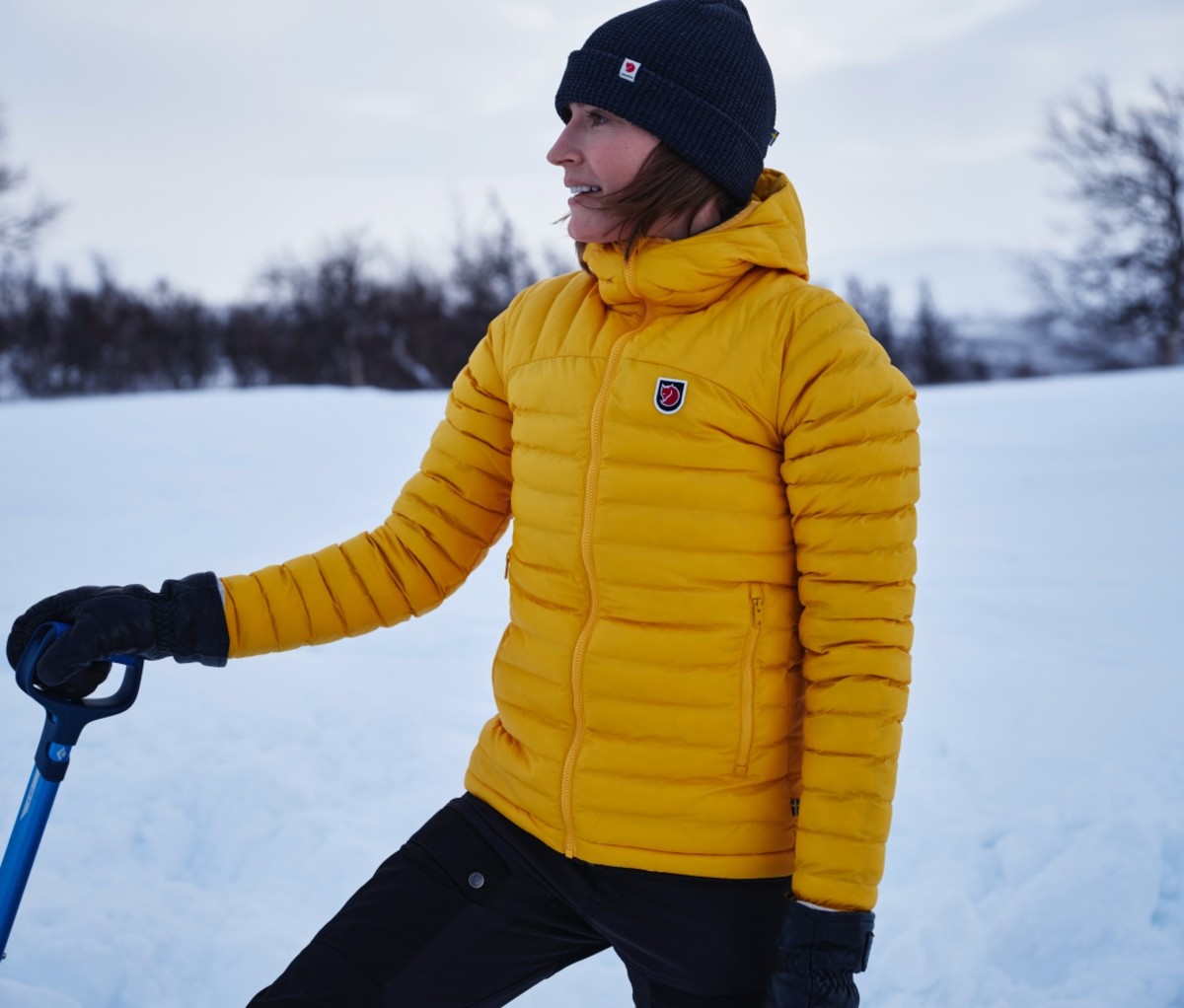 Woman wearing a yellow Lätt Hoodie