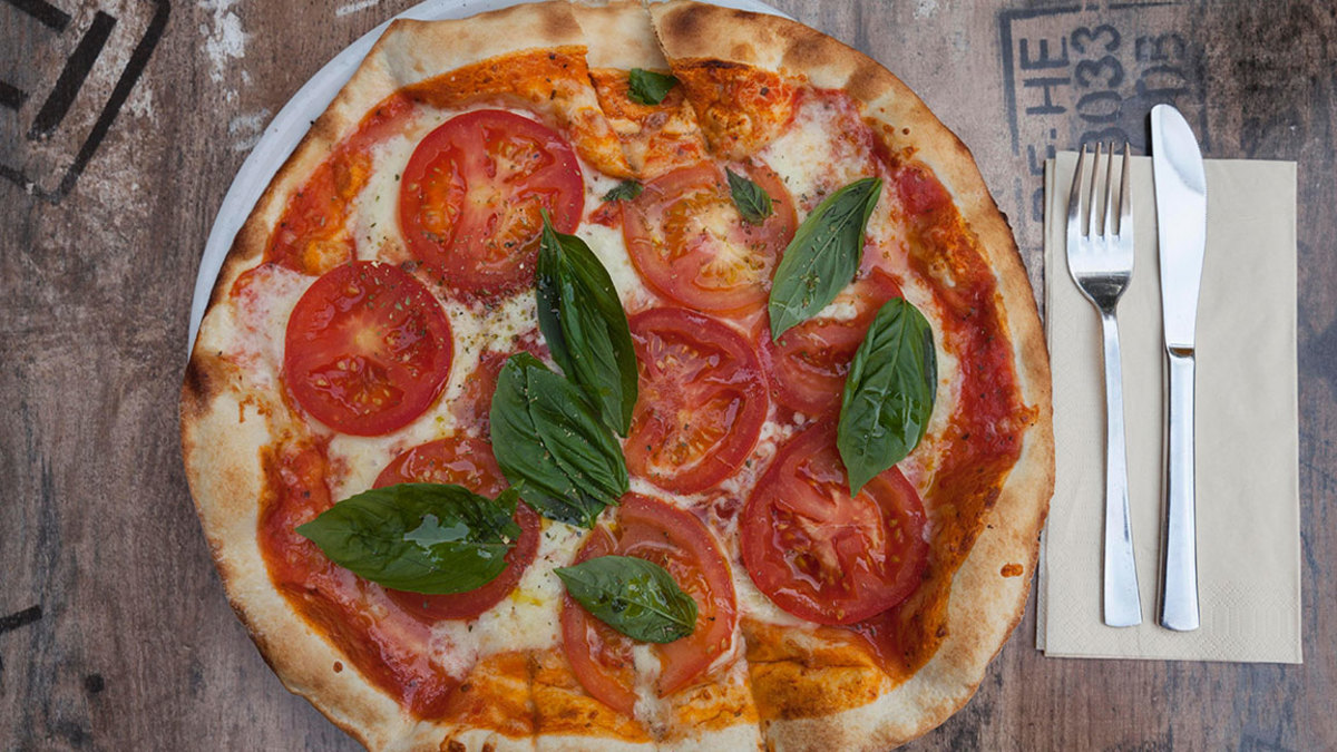 VARIOUS Pizza Margherita on plate, tomato, basil and mozzarella 2010s