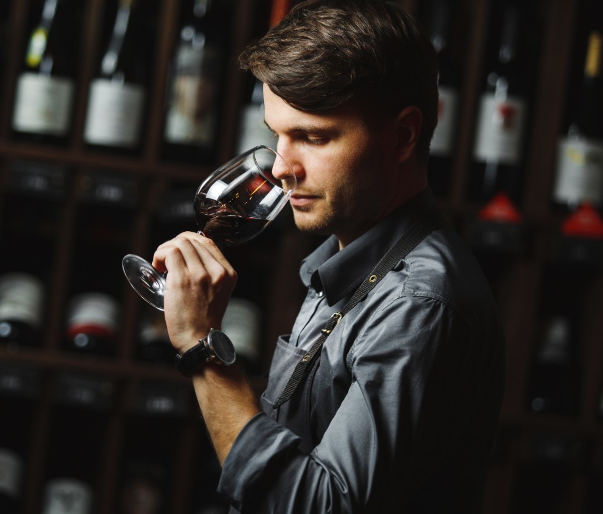 Man smelling a glass of wine.