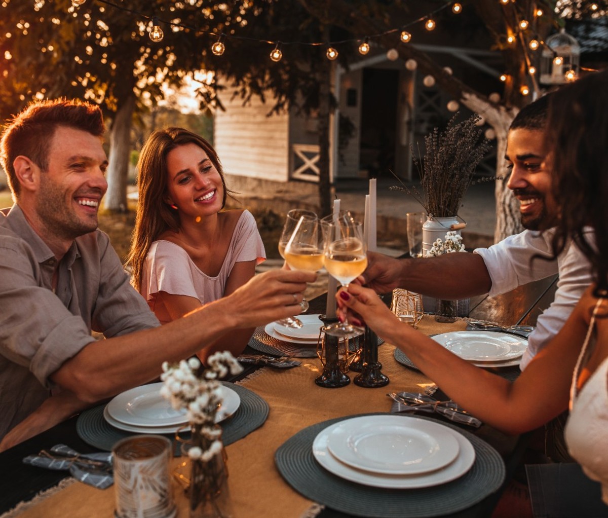 Two couple drinking wine outdoors.