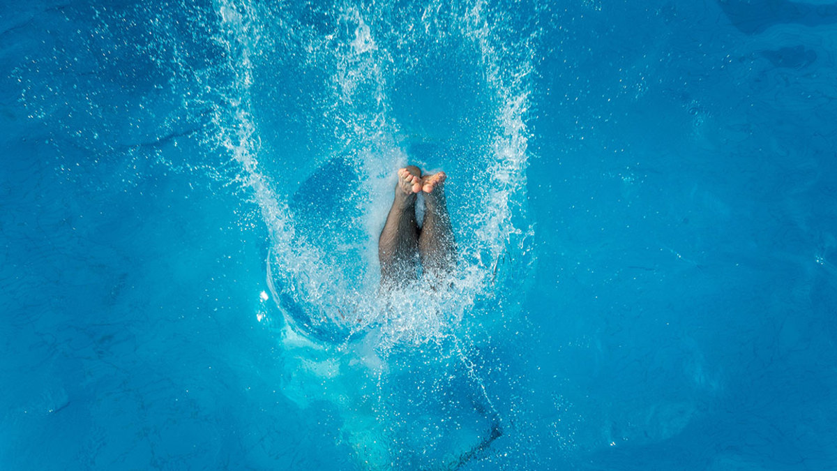 A man dives into the water after a jump from the 3 meter platform at the swimming pool 'Muehltalbad' on July 03, 2015 in Darmstadt, Germany. Temperatures across northern Europe are rising and in Germany a high of 37 degrees Celsius is forecast for the weekend. (Photo by Thomas Lohnes/Getty Images)