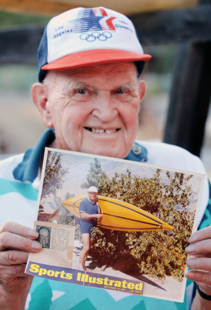 Tom Johnson holds a picture of him holding a fiberglass River Chaser that was taken in 1972. Photo: Dan Ocampo