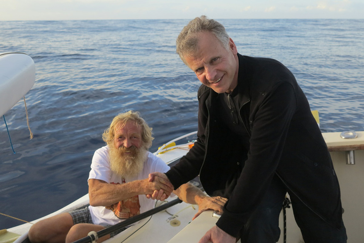 Piotr Chmielinski, right, greets Aleksander "Olek" Doba near Bermuda, 138 days after Doba left Lisbon, Portugal in a 23-foot kayak. Photo courtesy Piotr Chmielinski/Canoandes 