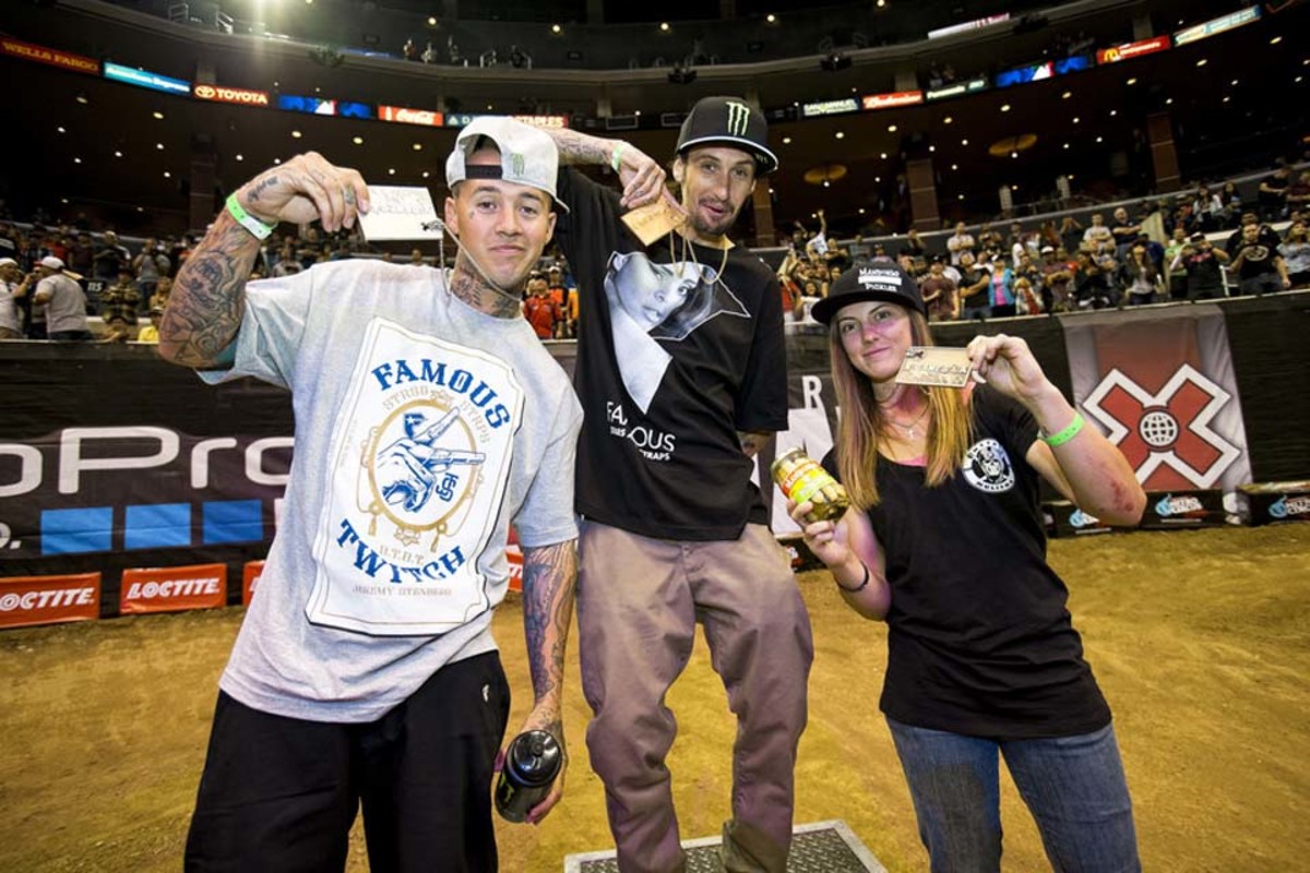 Motocross riders Jeremy Stenberg, Josh Hansen, and Vicki Golden on the podium after competing in Moto X Best Whip