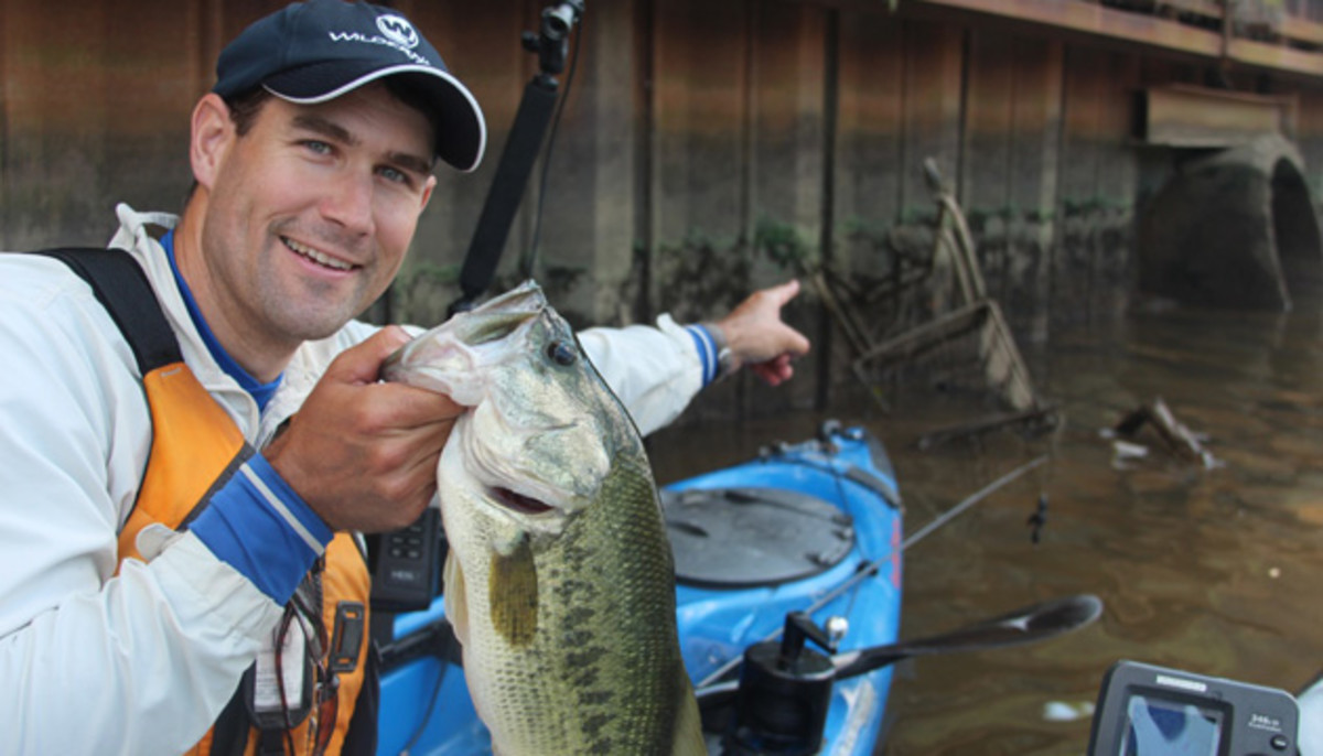 Anglers don't see all invasive species in the same light. The author is proud of this nice largemouth, plucked off unnatural structure - a drowned shopping cart. Photo Jeff Little.